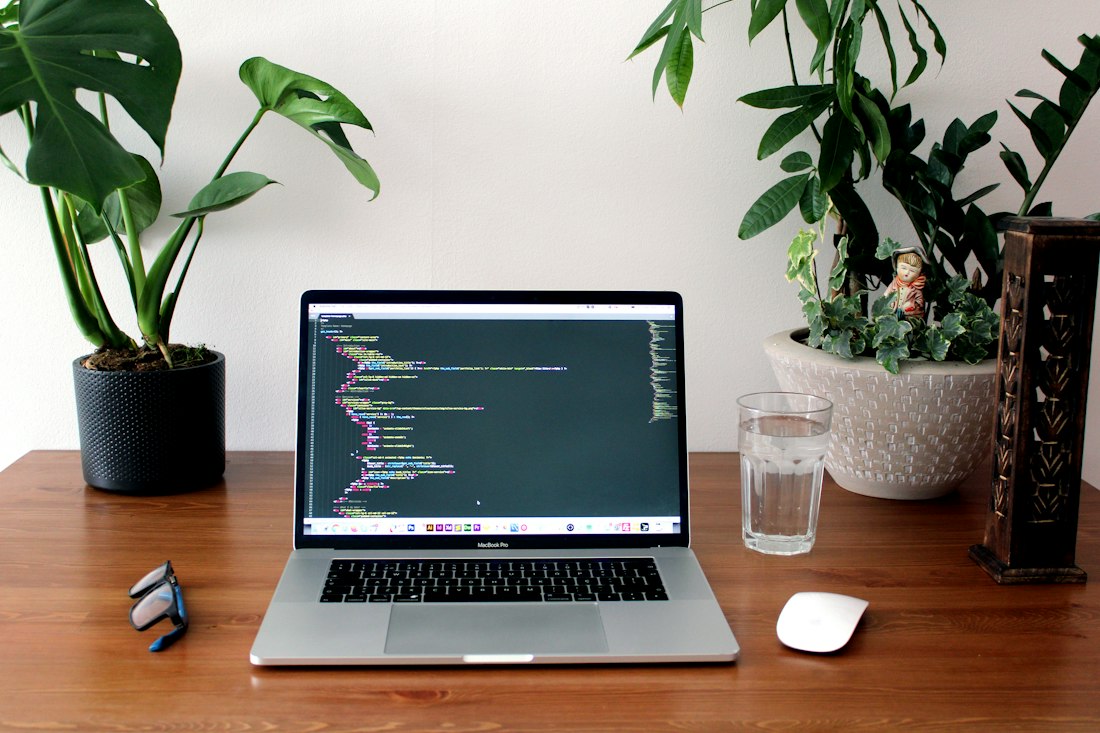 Software code on a laptop at a desk